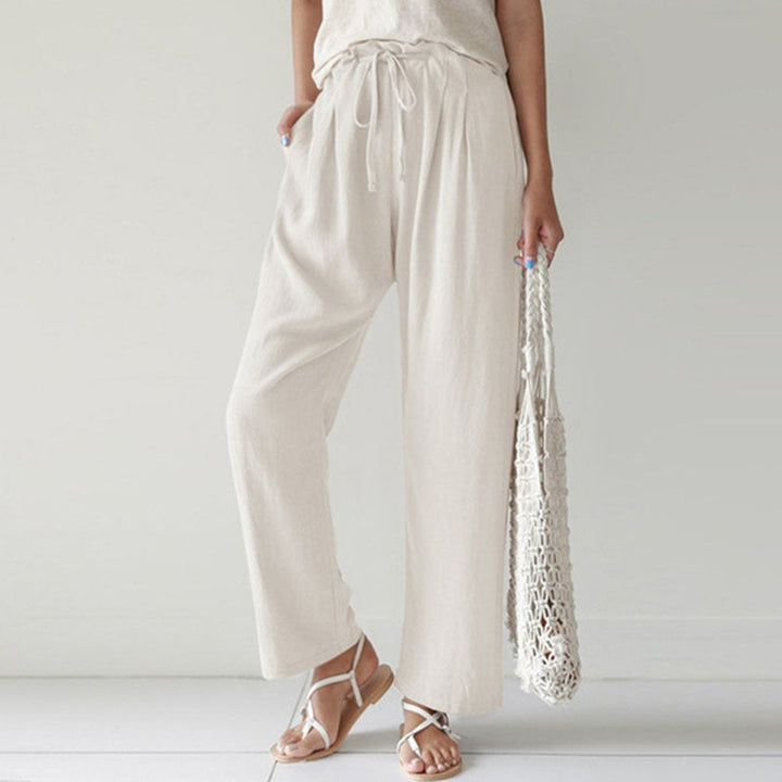 A woman walking outdoors in relaxed drawstring pants with an easy, comfortable everyday look.
