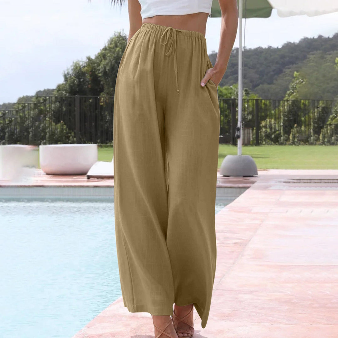 A woman in loose wide-leg summer pants styled with a light top for an easy warm-weather look.