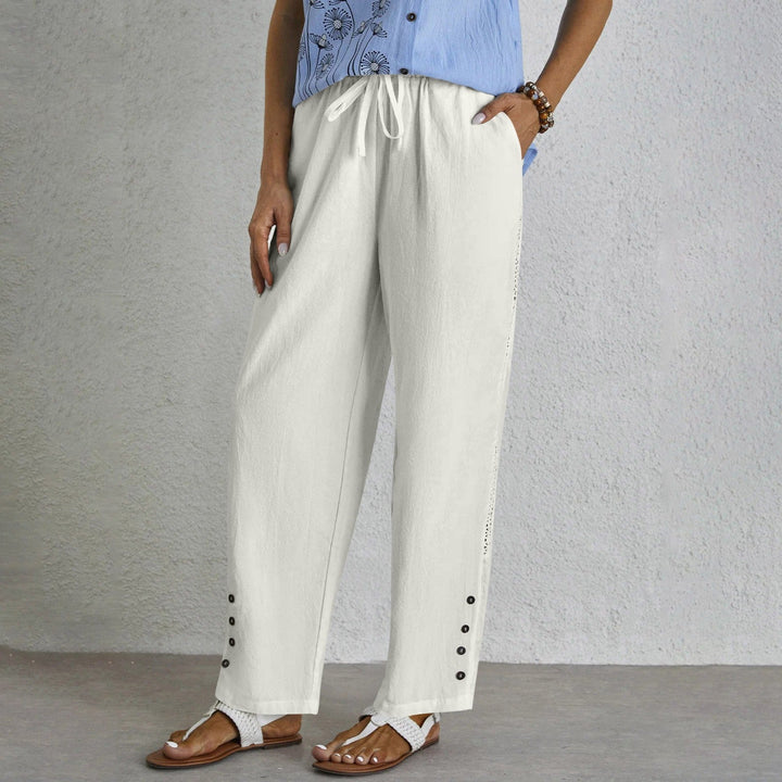 Woman wearing relaxed button-detail pants with a simple top, out for the day.