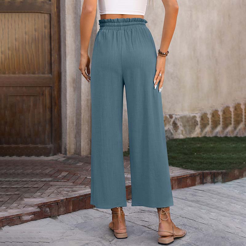 A woman in light cropped wide-leg pants styled with sandals for a relaxed summer look.