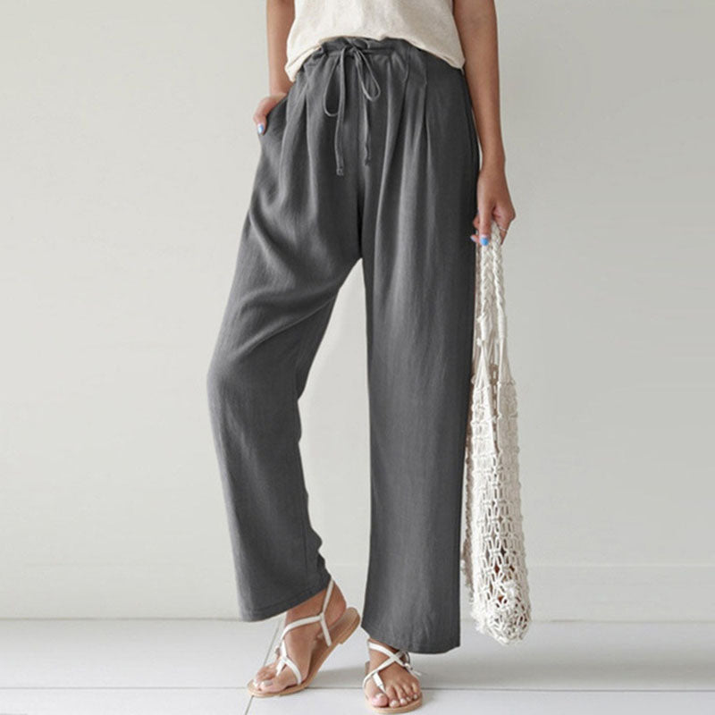 A woman walking outdoors in relaxed drawstring pants with an easy, comfortable everyday look.
