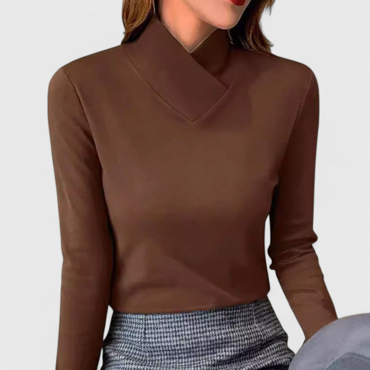 A woman wearing an elegant stand-collar sweater, slim and refined with a flattering line.