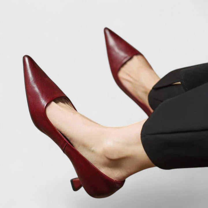 A woman in classic black pointed-toe comfort heels moving easily from office to evening.