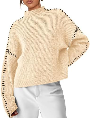A woman wearing an oversized mock-neck sweater with whipstitch detailing, cosy and stylish.