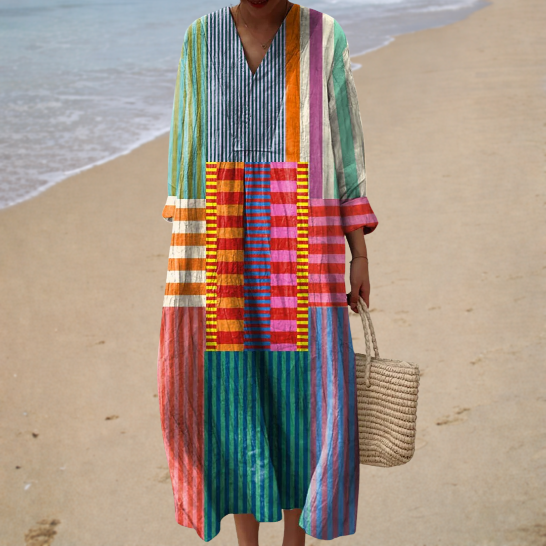 A woman in an airy printed summer dress, the skirt flowing gently around her in the summer light.
