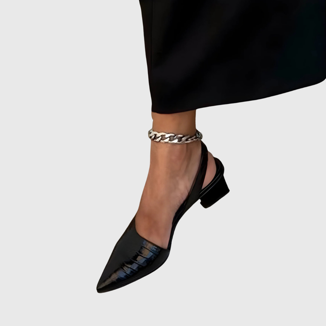 A woman wearing black comfort block heels with a roomy toe box and cushioned sole.
