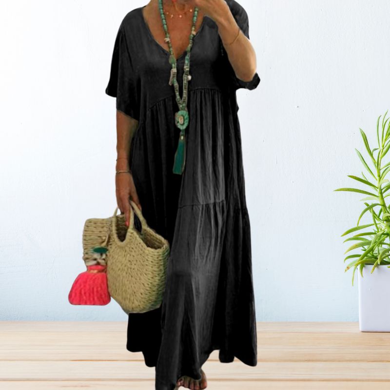 Woman wearing a relaxed V-neck maxi dress with a soft, flowing drape.