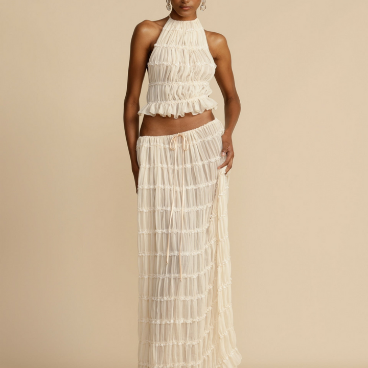 A woman wearing a strappy top with a matching summer skirt