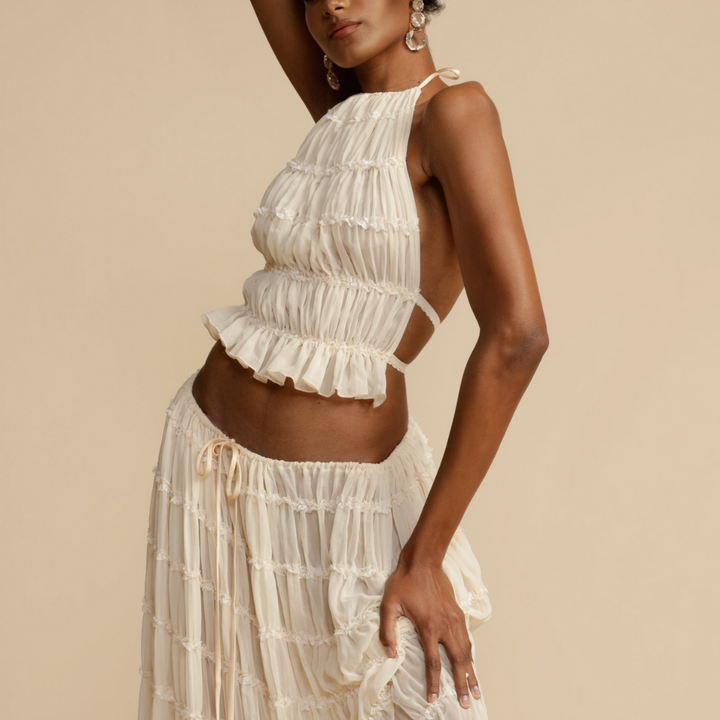 A woman wearing a strappy top with a matching summer skirt