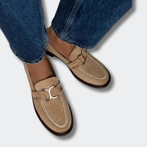 A woman wearing soft-finish slip-on loafers, styled for a relaxed day out.