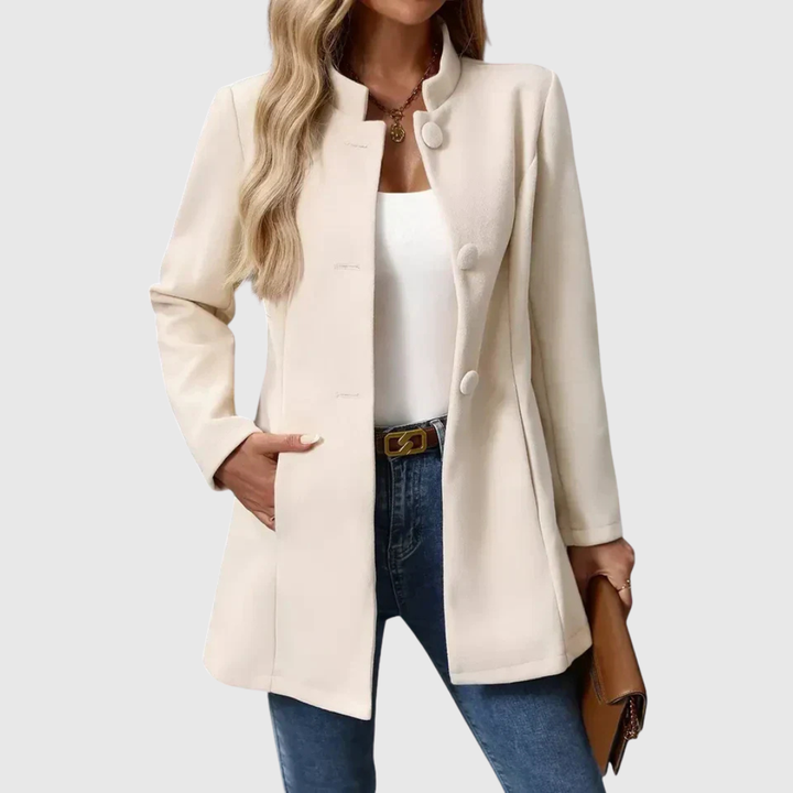 A woman wearing a tailored jacket with a neat stand collar and a button front
