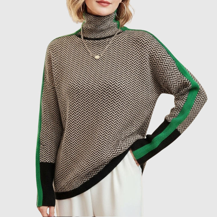 A woman wearing a brown and beige chevron high-collar sweater with bright green side stripes.