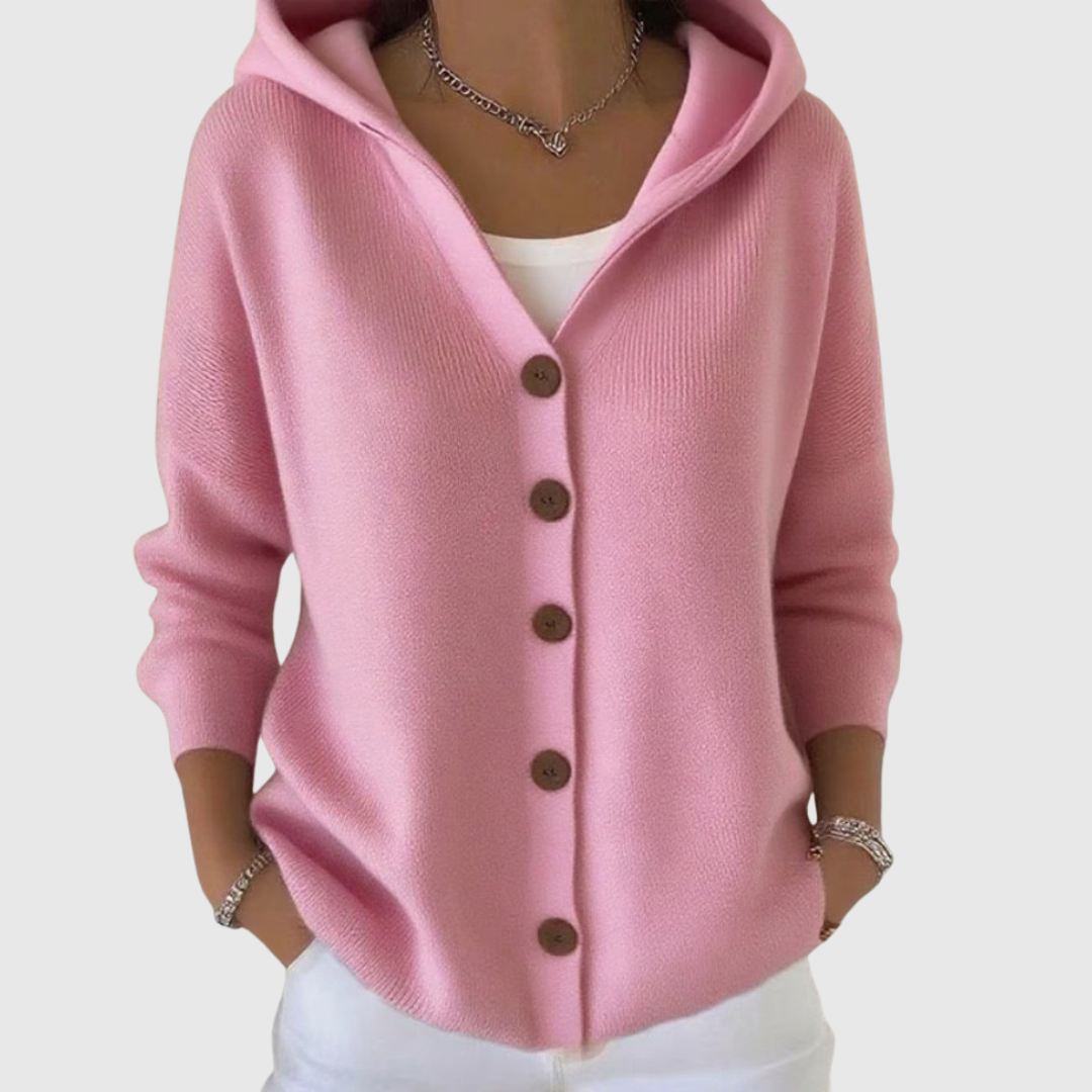 A woman wearing a soft hooded comfort cardigan worn open over a top on a mild spring day.