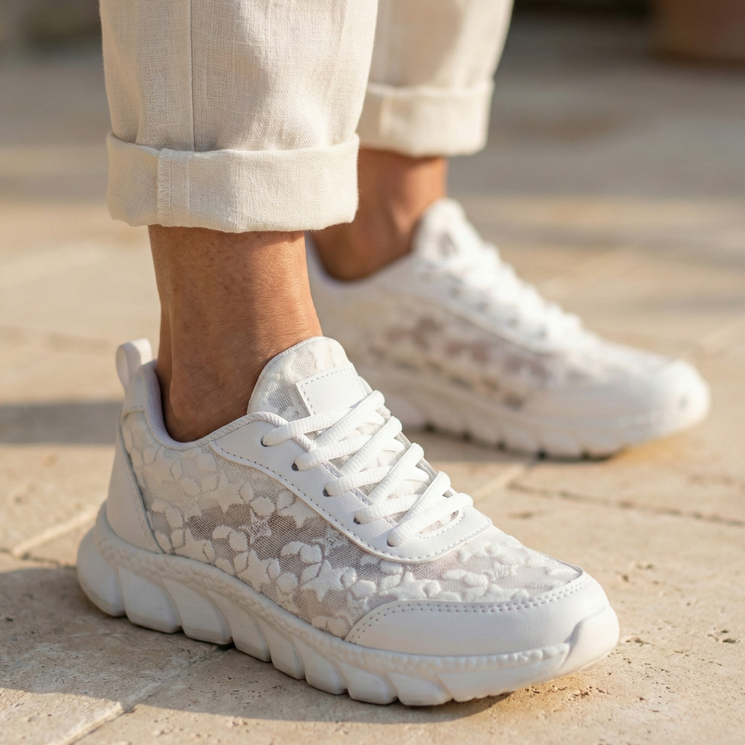 A woman wearing clean white cushioned comfort sneakers