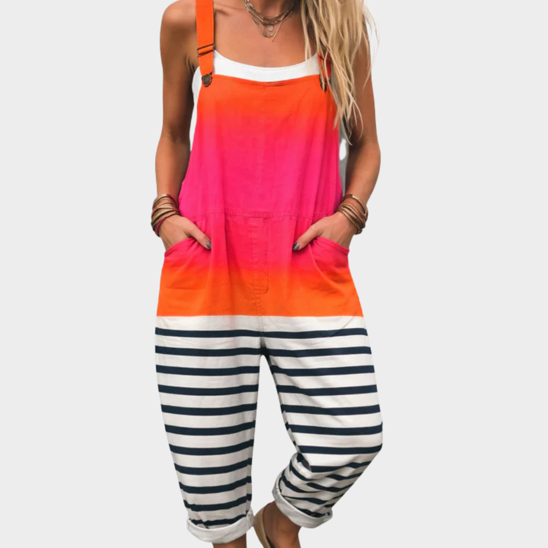Woman wearing overalls with an orange-to-pink gradient top and navy-and-white striped legs