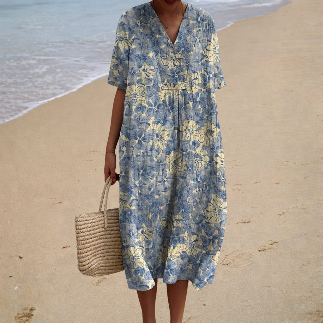 A woman wearing a relaxed printed summer dress with a soft, easy drape on a summer day.
