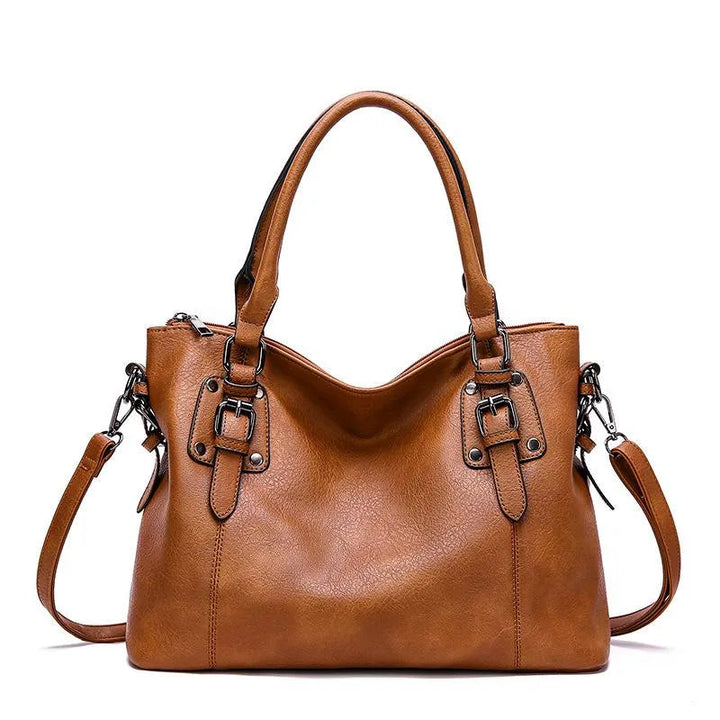 A woman carrying a soft slouchy shoulder bag with a rich finish on a relaxed day out