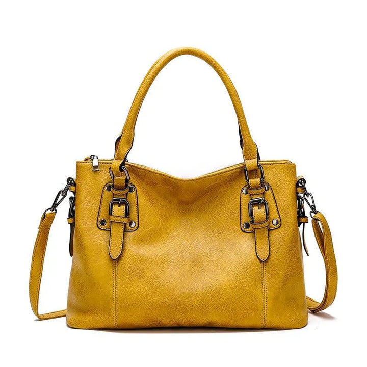 A woman carrying a soft slouchy shoulder bag with a rich finish on a relaxed day out
