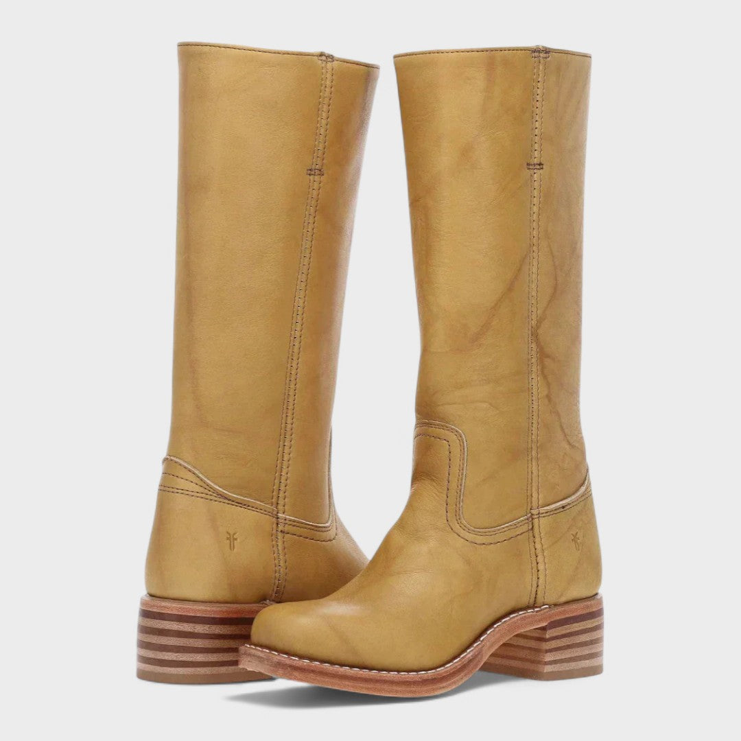 A woman wearing tall classic riding boots with jeans on a country walk.