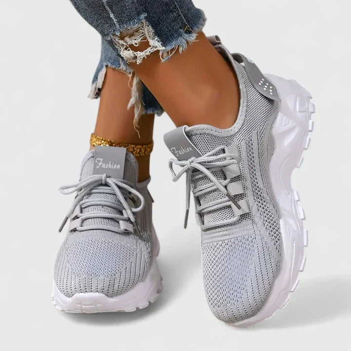 A woman wearing wide-toe cushioned orthopaedic sneakers
