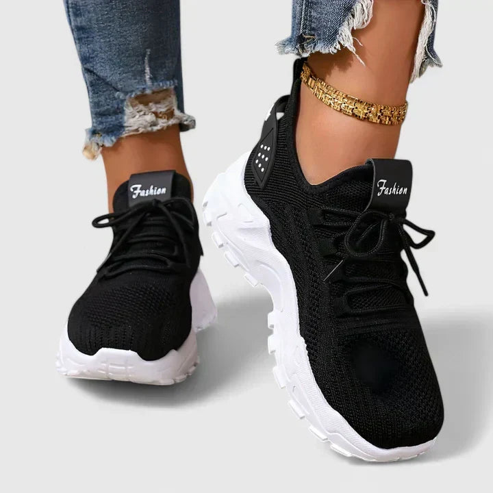 A woman wearing wide-toe cushioned orthopaedic sneakers