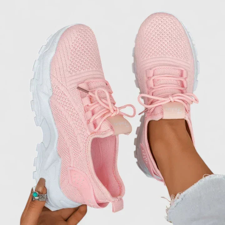 A woman wearing wide-toe cushioned orthopaedic sneakers