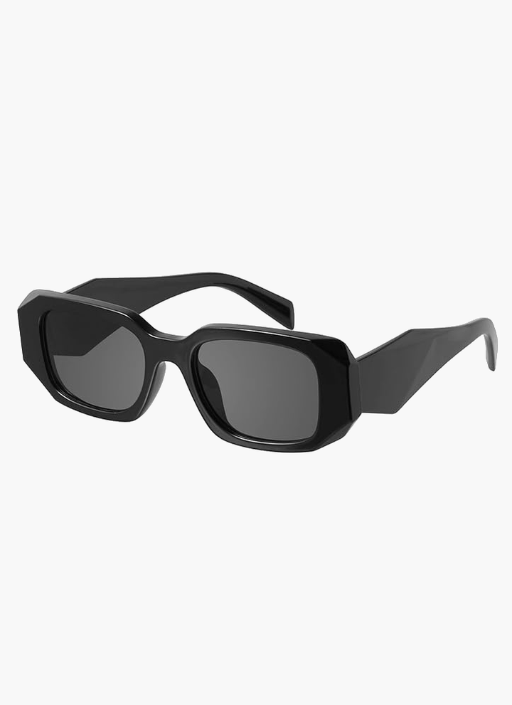 A woman wearing bold glare-reducing sunglasses on a bright day outdoors.