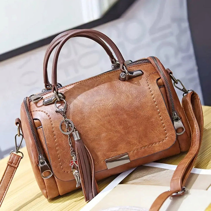 A woman carrying a textured everyday bag on her shoulder while out for the day.