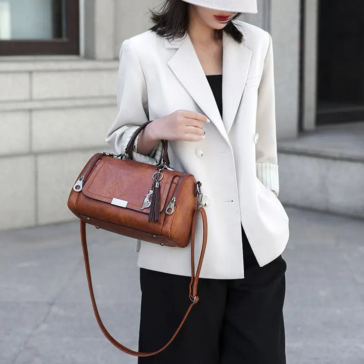 A woman carrying a textured everyday bag on her shoulder while out for the day.