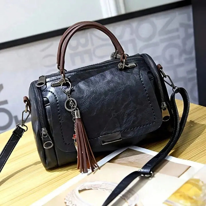 A woman carrying a textured everyday bag on her shoulder while out for the day.