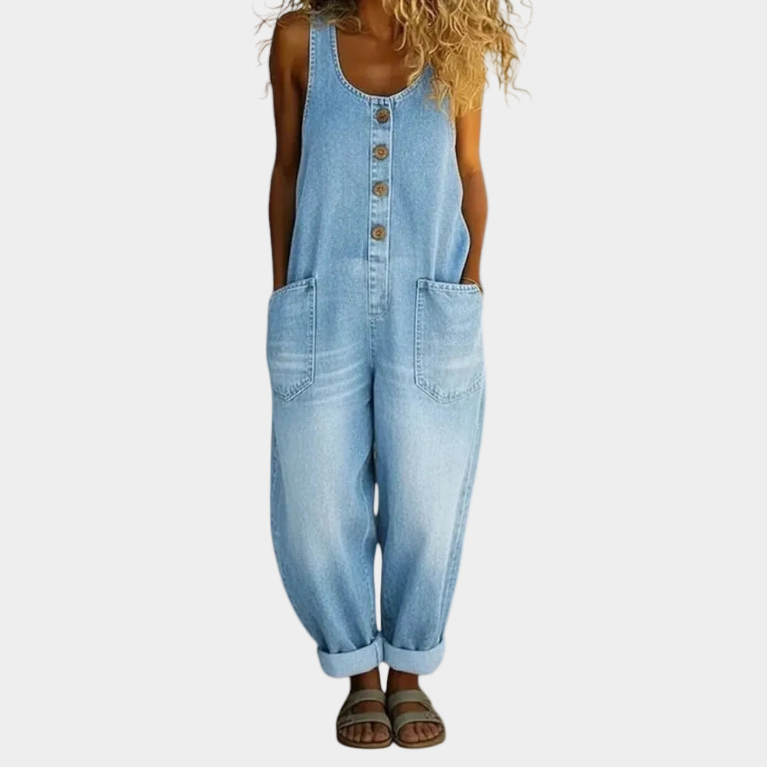 A woman wearing light blue wide-leg vintage overalls with a buttoned front and roomy patch pockets.