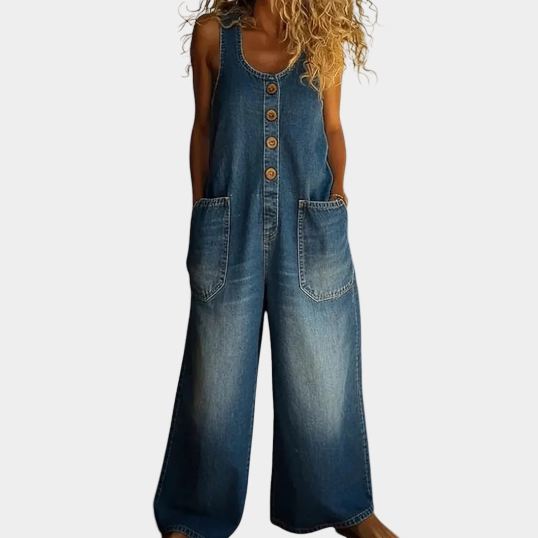 A woman wearing light blue wide-leg vintage overalls with a buttoned front and roomy patch pockets.