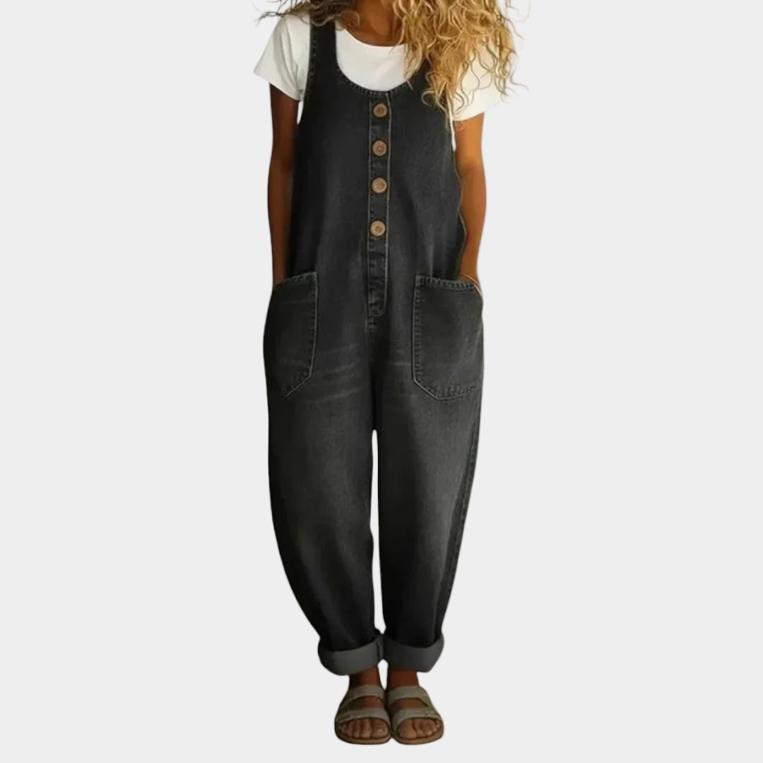 A woman wearing light blue wide-leg vintage overalls with a buttoned front and roomy patch pockets.