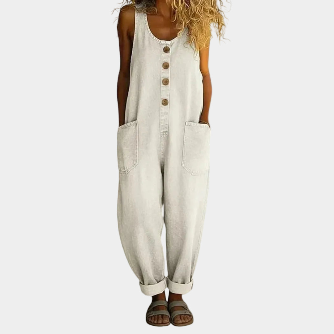 A woman wearing light blue wide-leg vintage overalls with a buttoned front and roomy patch pockets.