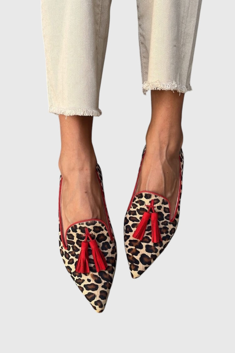A woman wearing leopard print slip-on loafers, styled with jeans for an easy everyday look.