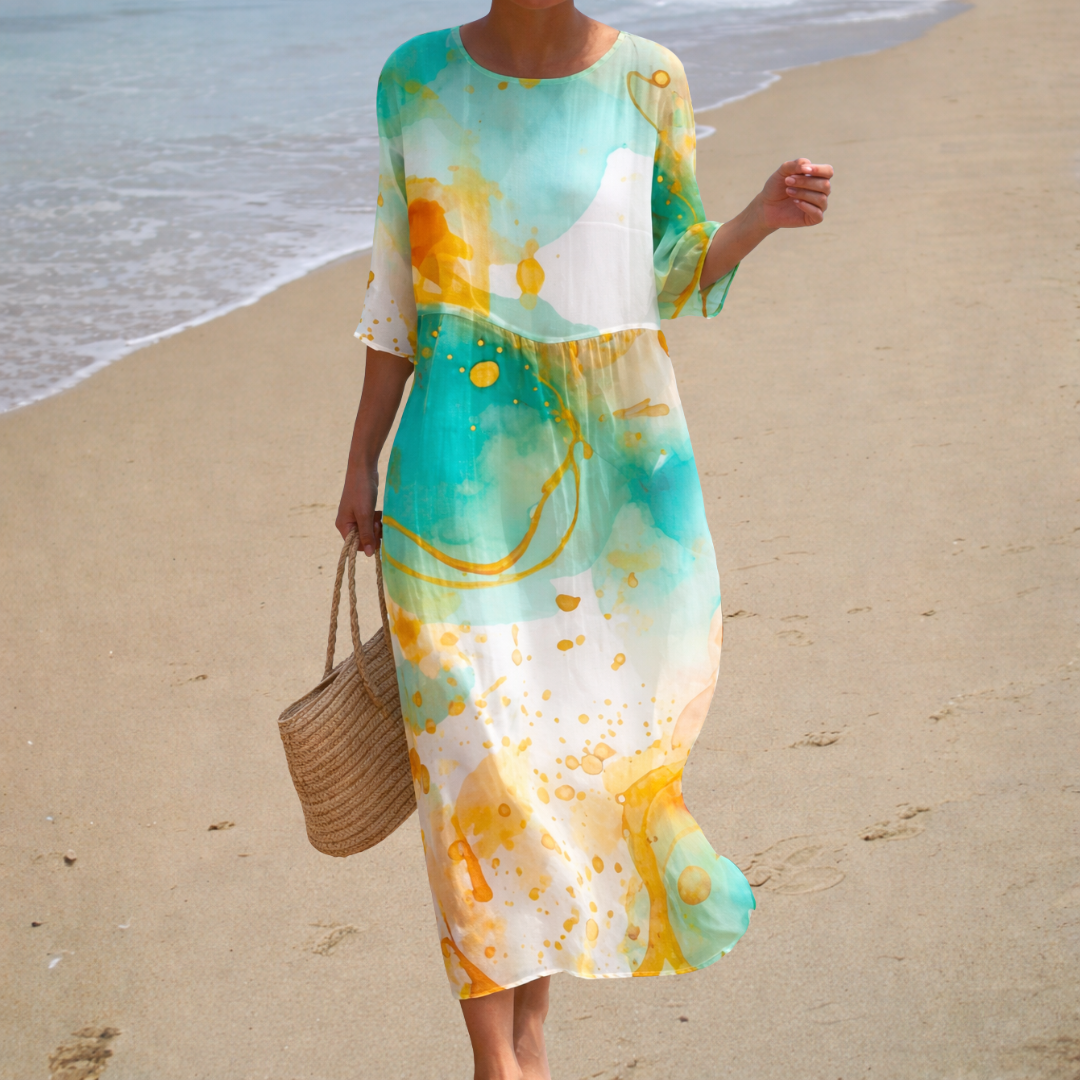 A woman in a long, flowing printed dress that drifts elegantly around her as she strolls in the evening sun.