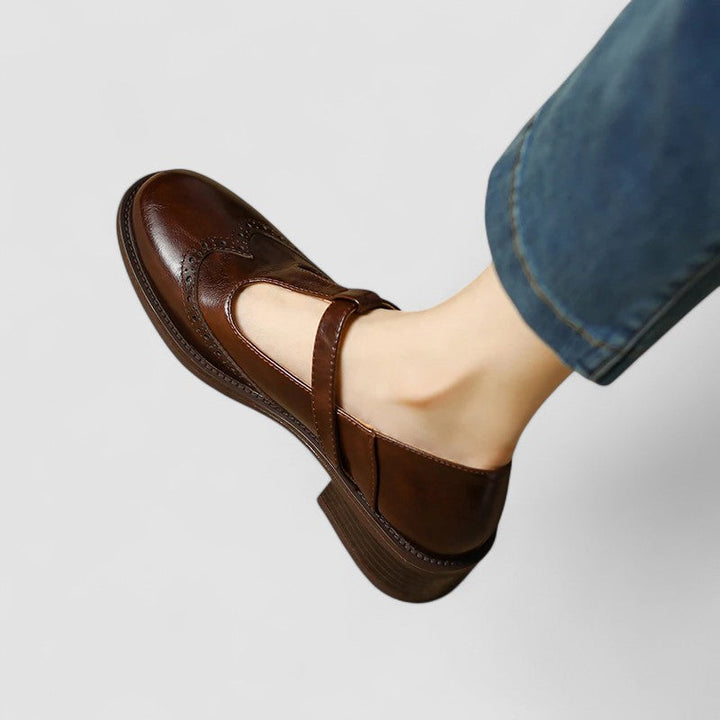 A woman in beige T-strap Mary Jane shoes, comfortable and balanced on a busy day.