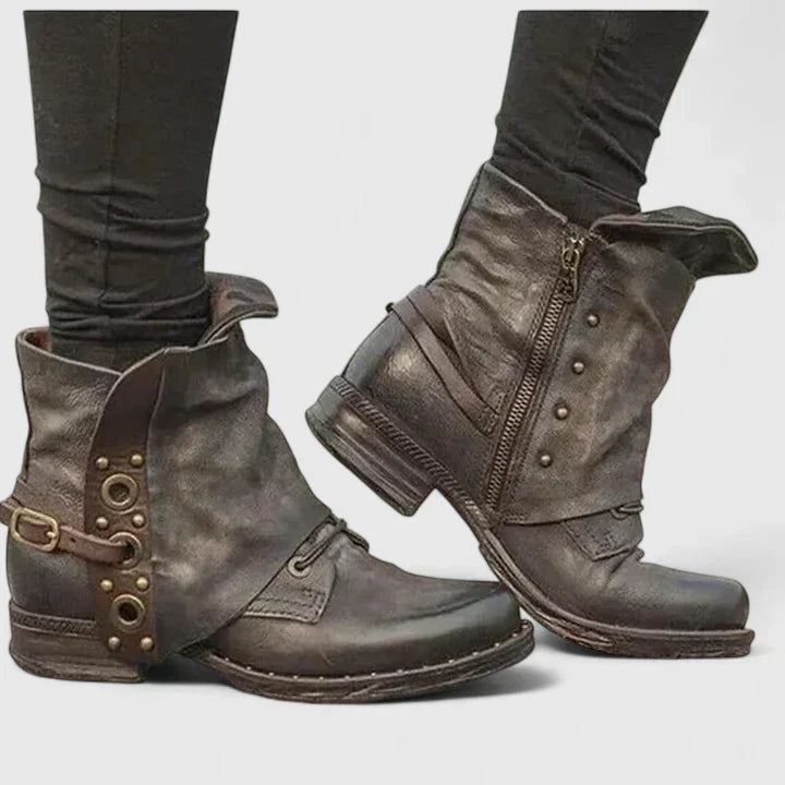 Woman wearing grey supportive ankle boots, walking confidently through town.