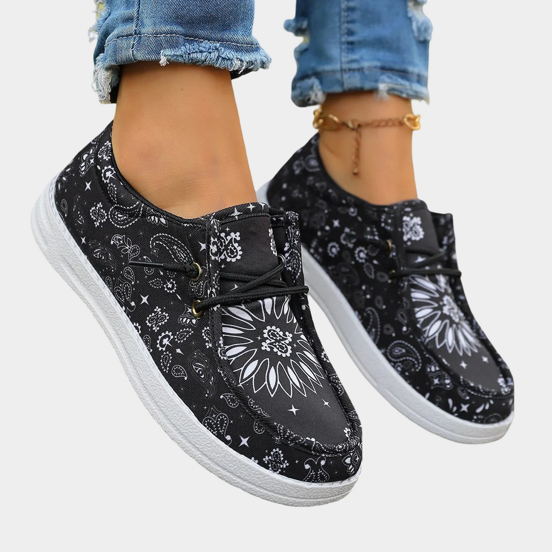A woman wearing crisp black and white boho-print lace-up comfort shoes on a day out.