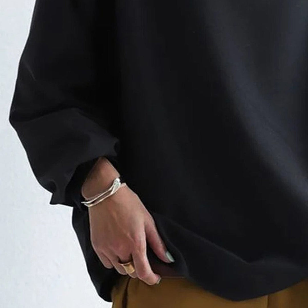 A woman wearing a soft funnel neck sweater styled with jeans for a relaxed elegant look.