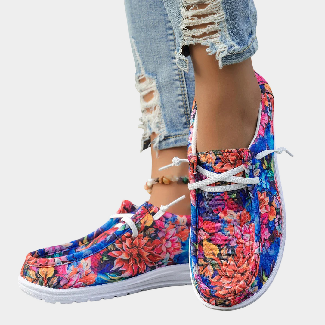 A woman wearing floral-print lace-up comfort shoes on a bright day out.