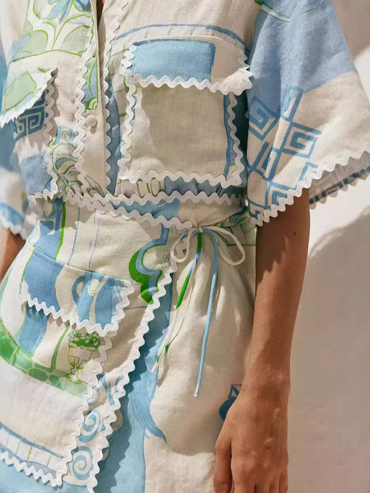 A woman wearing a patchwork print short-sleeve top and matching tie-waist shorts on a sunny day