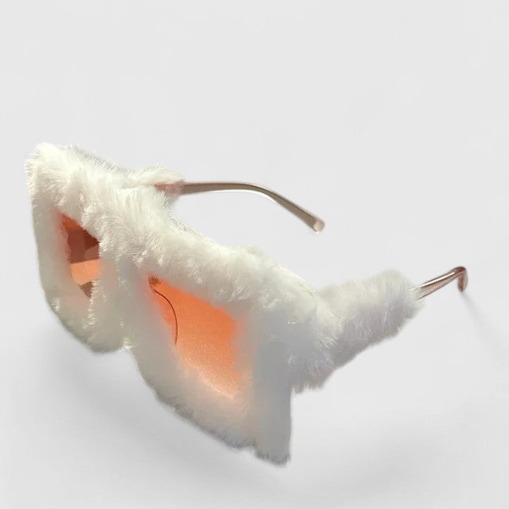 A bold pair of sunglasses with a soft red fluffy trim around the frame and slim black arms.