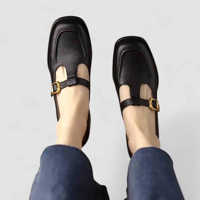 A woman wearing brown T-strap Mary Jane shoes, steady and comfortable through the day.
