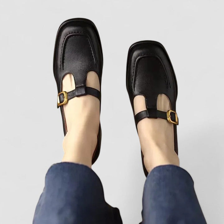 A woman wearing brown T-strap Mary Jane shoes, steady and comfortable through the day.