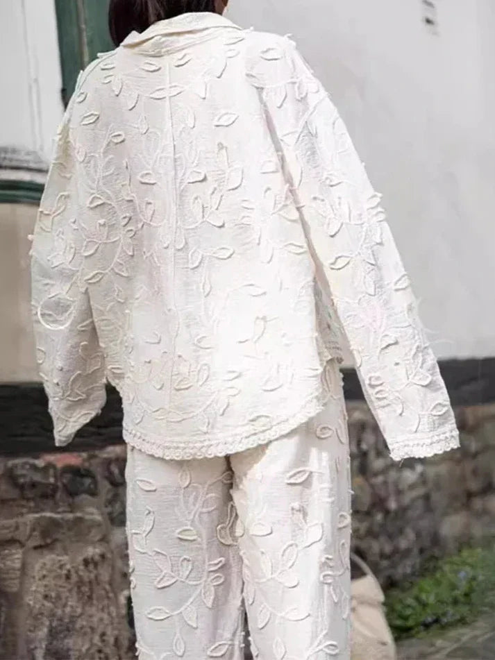 A woman wearing an embroidered relaxed two-piece set with wide pants