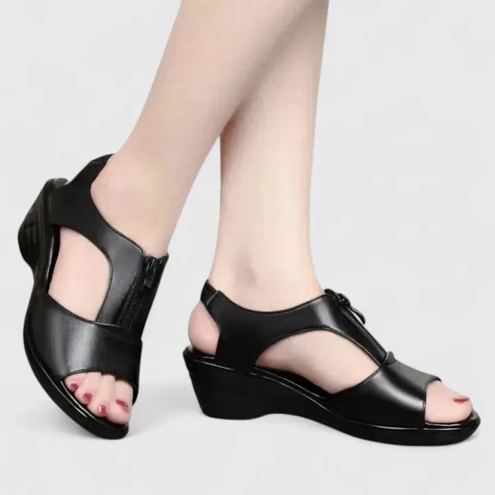 Black peep-toe sandals with a buckled instep strap and a sturdy block heel.