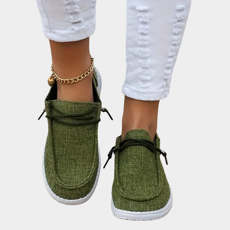 A woman wearing olive green lace-up comfort shoes on a country walk.