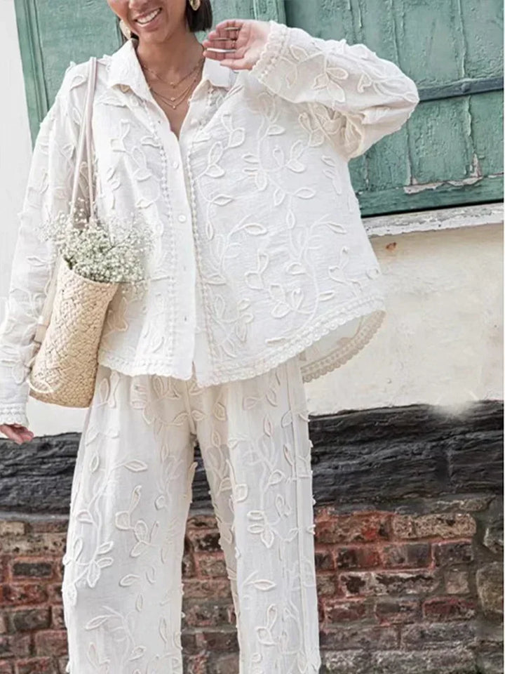 A woman wearing an embroidered relaxed two-piece set with wide pants