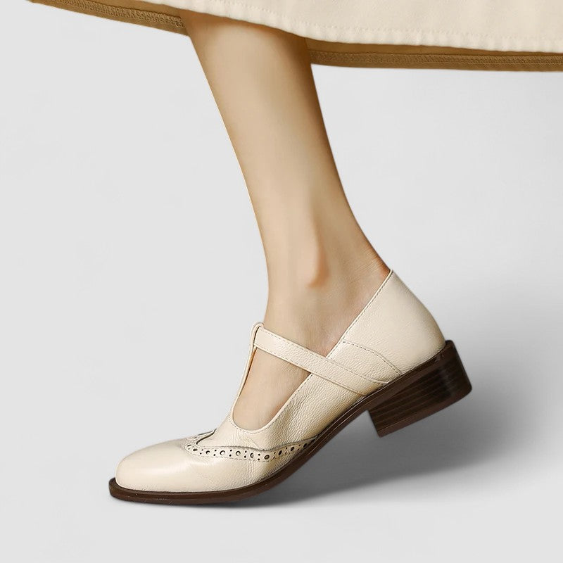A woman in beige T-strap Mary Jane shoes, comfortable and balanced on a busy day.